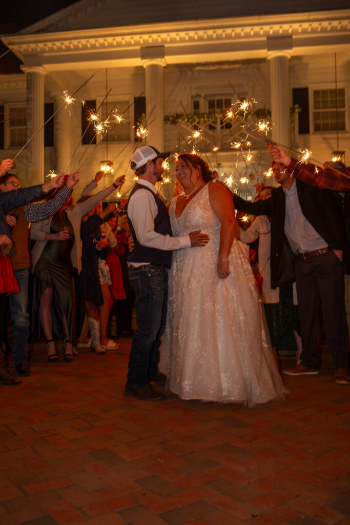 Bride and Groom during sparkler exit outside Magnolia Mansion venue