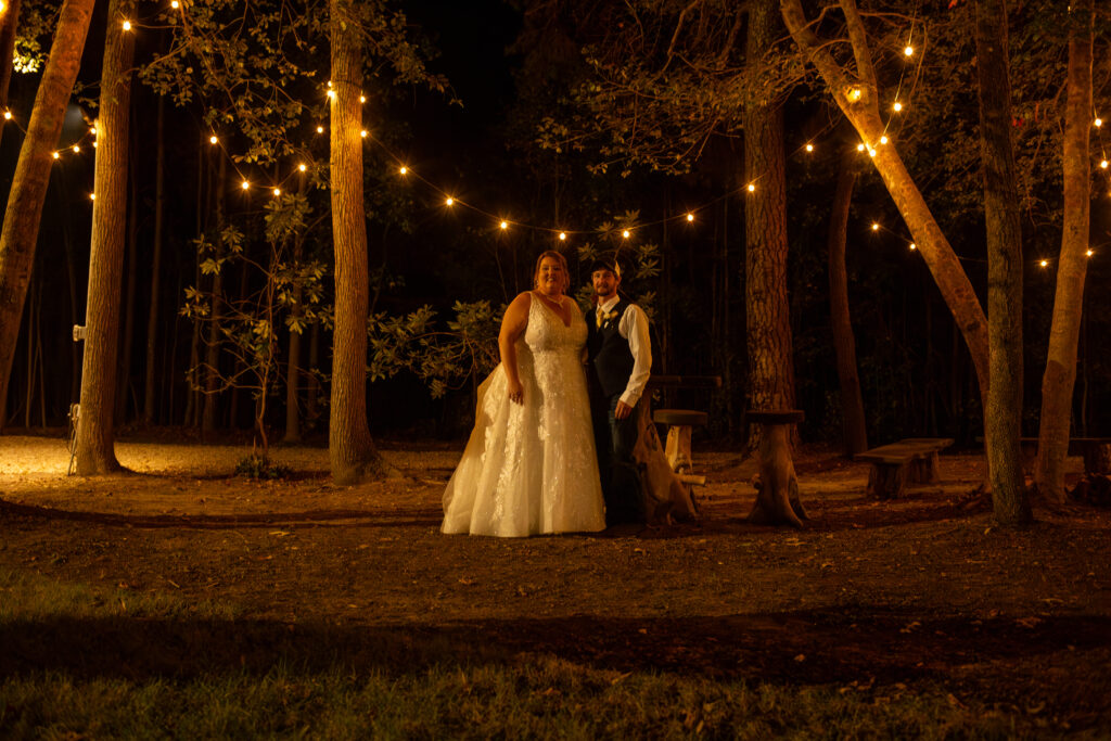 Bride and groom sneak away for a moment in the venue twinkle light/