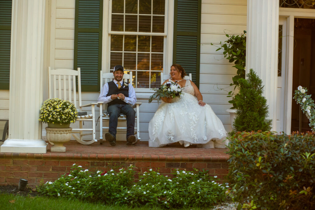 Bride and groom sitting on front porch